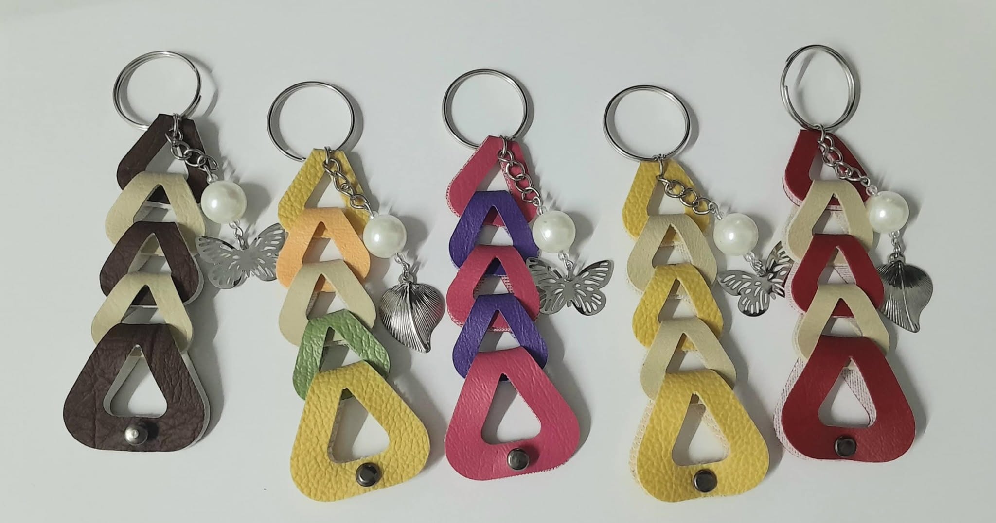 Handmade leather charm keychains with pearls and butterflies